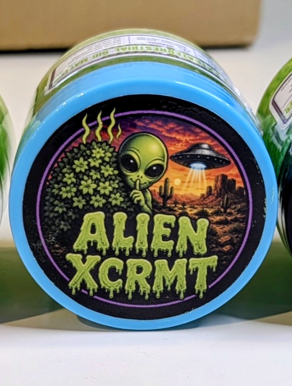 Alien XCRMT slime tub with green alien label, purple ring and dripping green logo